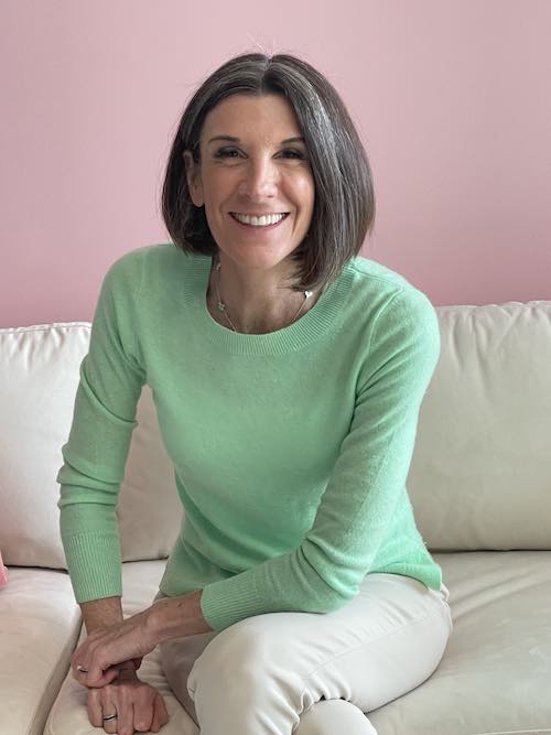 Laura Graye, medical intuitive, sitting on couch